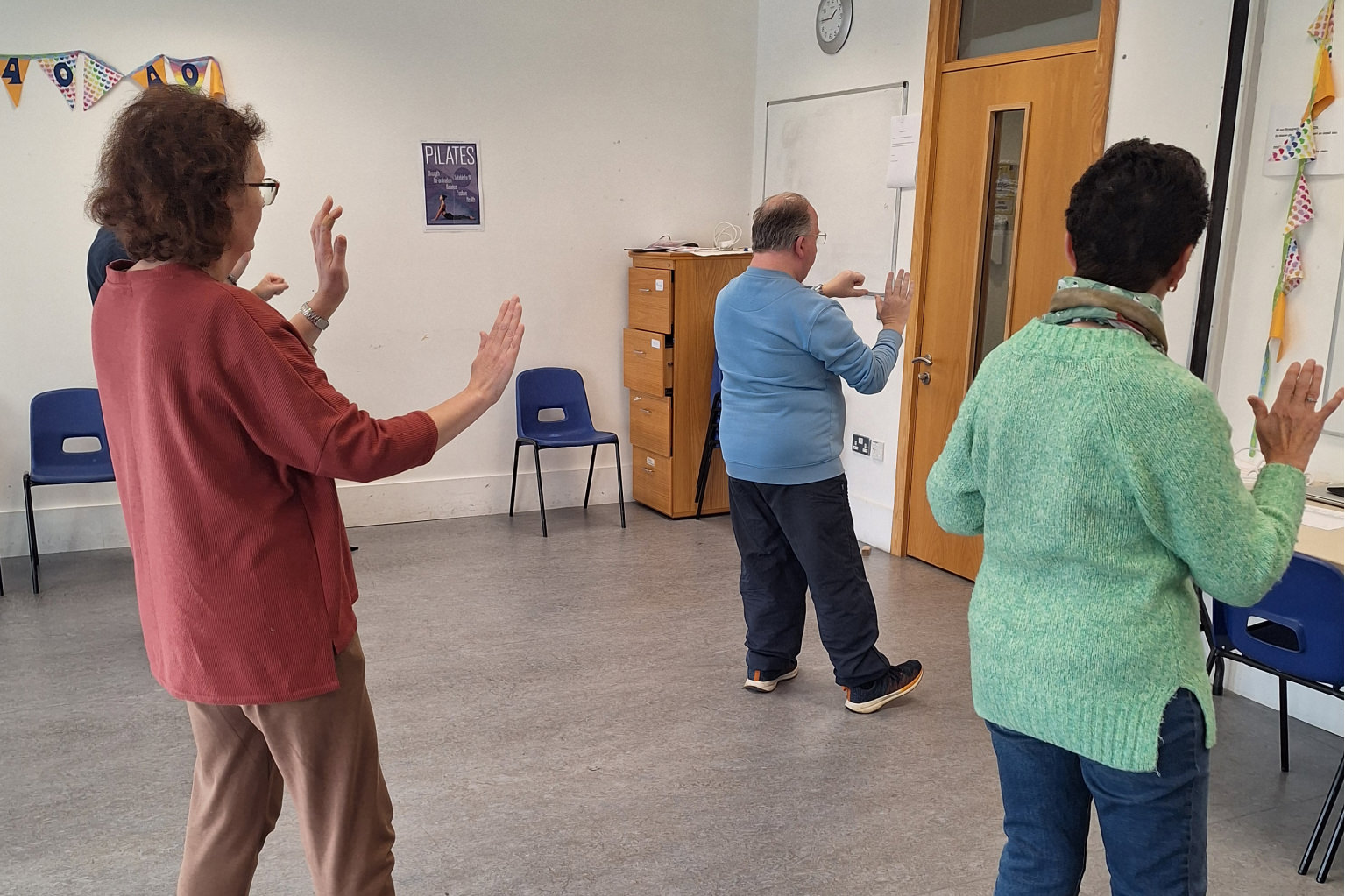 Students performing movements in Tai Chi class.